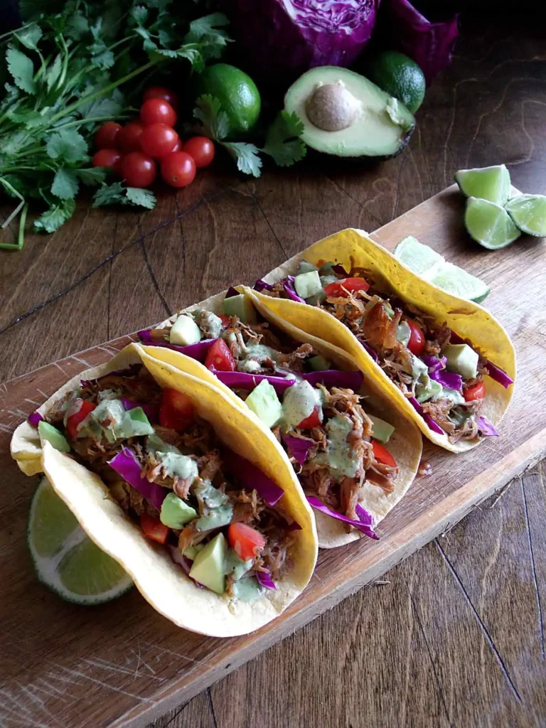 slow cooker carnitas tacos with cilantro-lime sauce