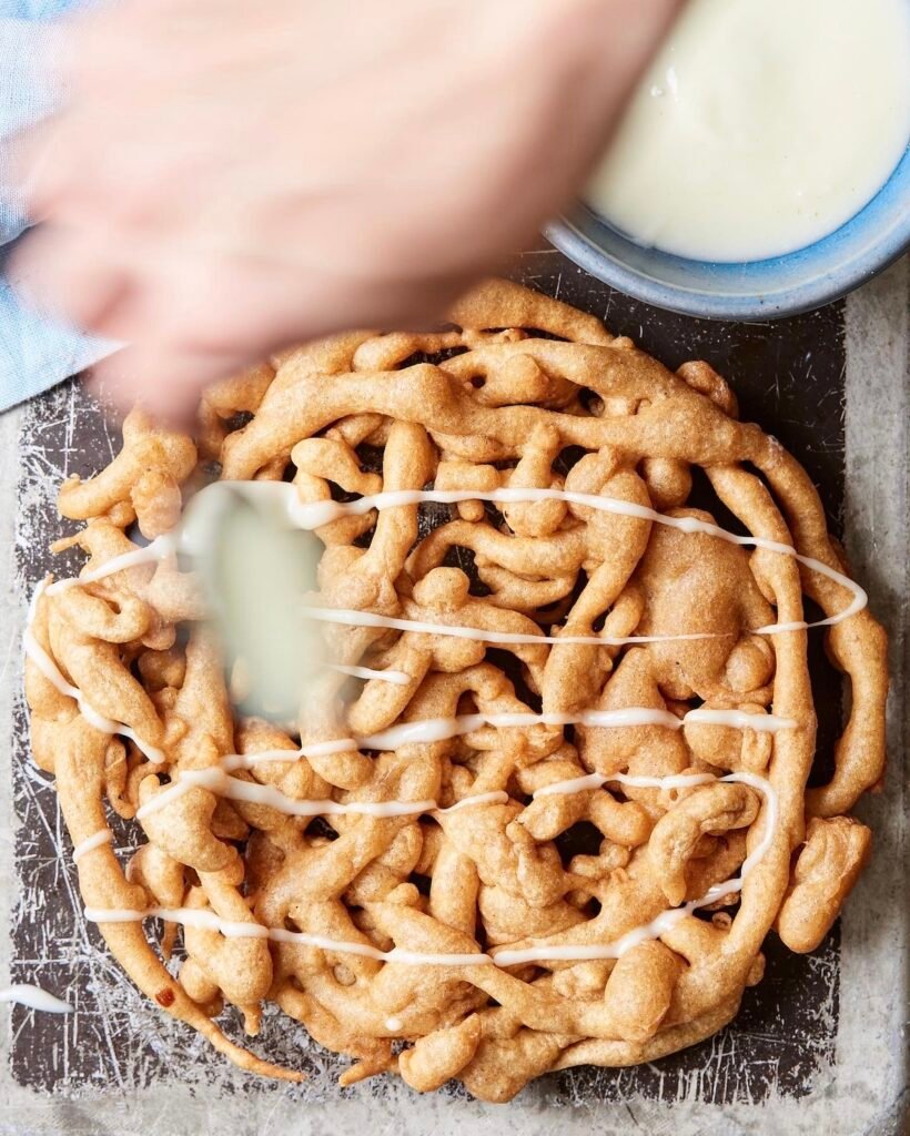 Cinnamon Roll Funnel Cake With Cream Cheese Frosting