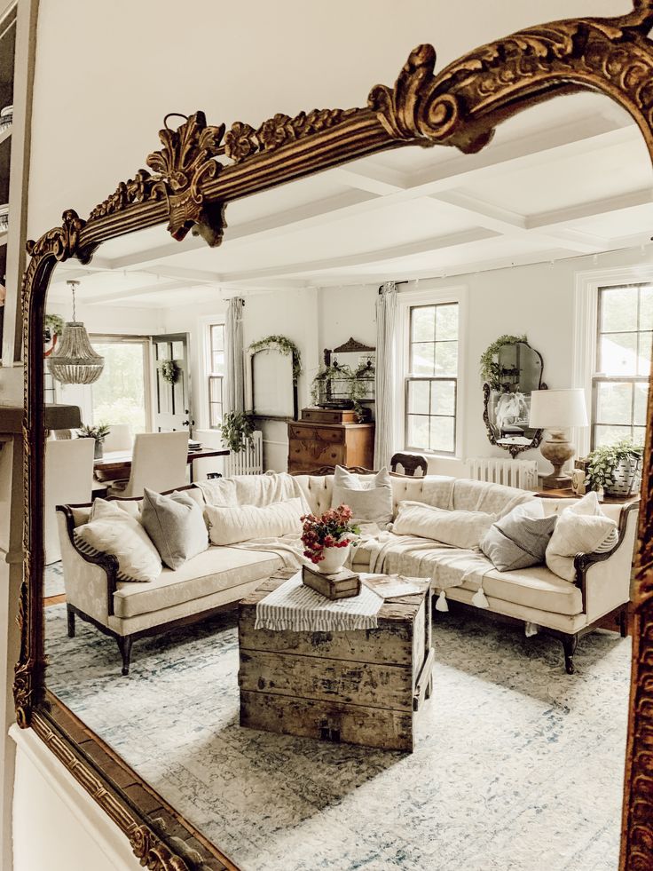 a vintage living room with antique mirrors