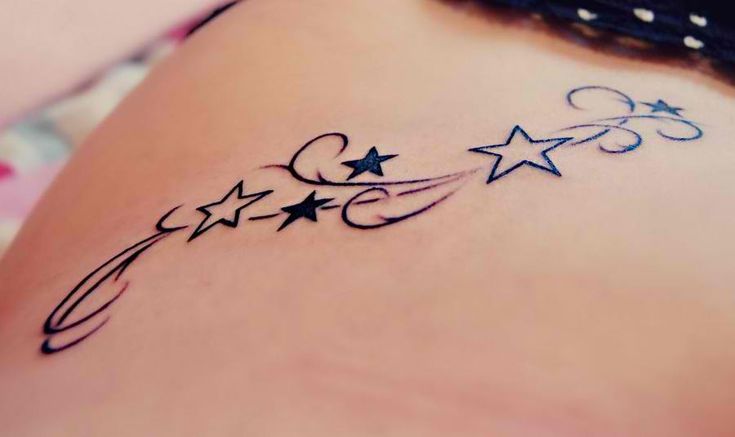 a beautiful shooting star tattoo on ribcage