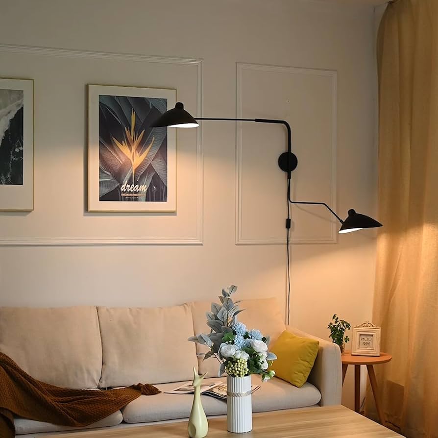 living room with swing-arm wall lamps with exposed bulbs