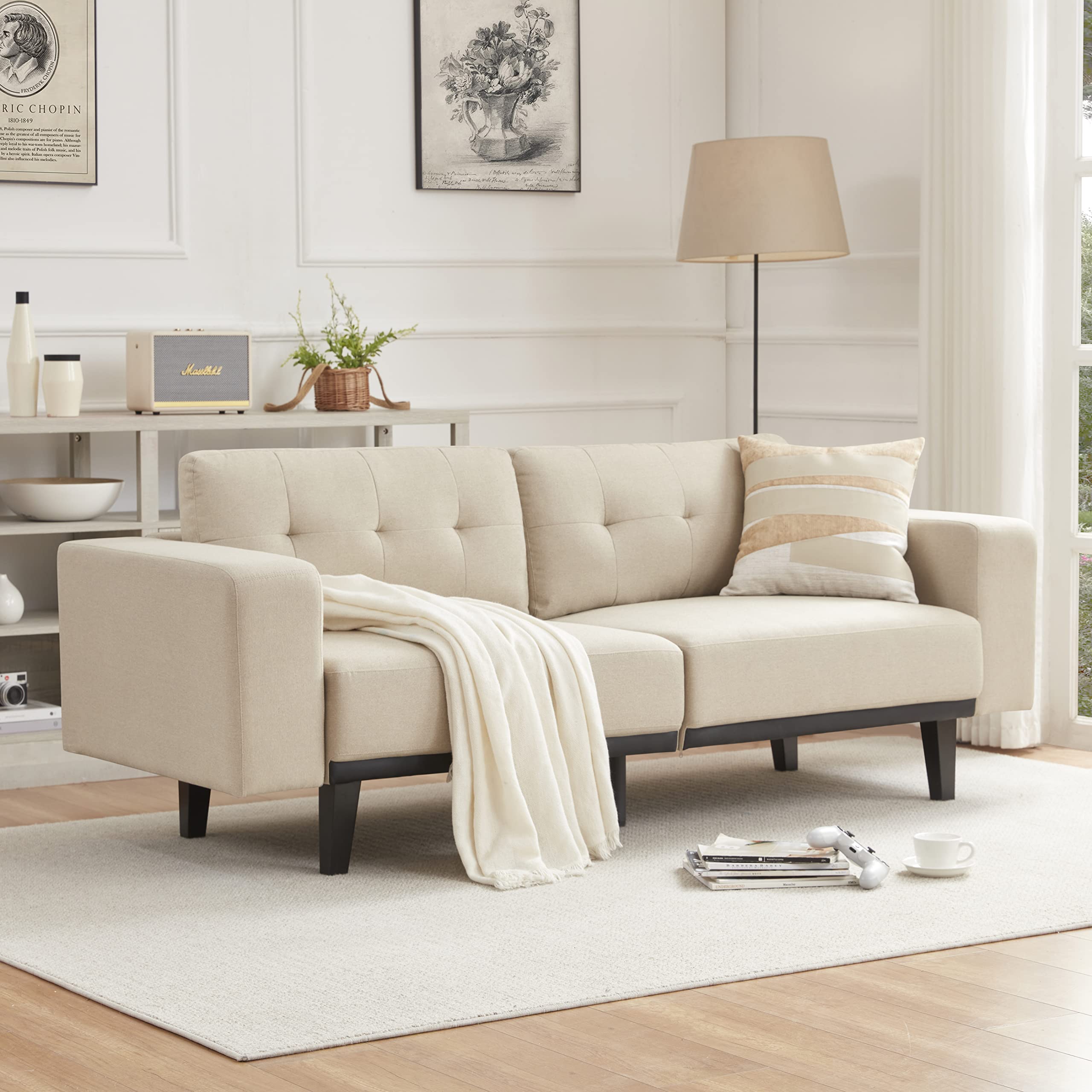 living room with mid-century modern cream leather sofa on tapered legs
