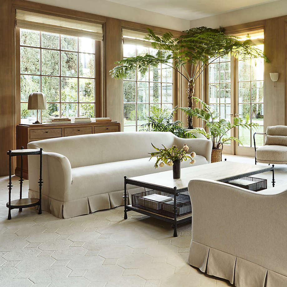 living room with elegant cream silk sofa with pleated details