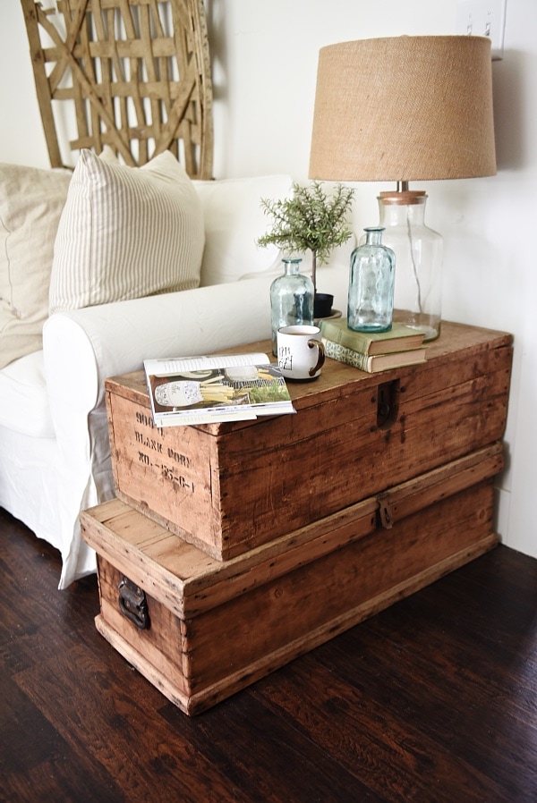 a vintage living room with trunk side table