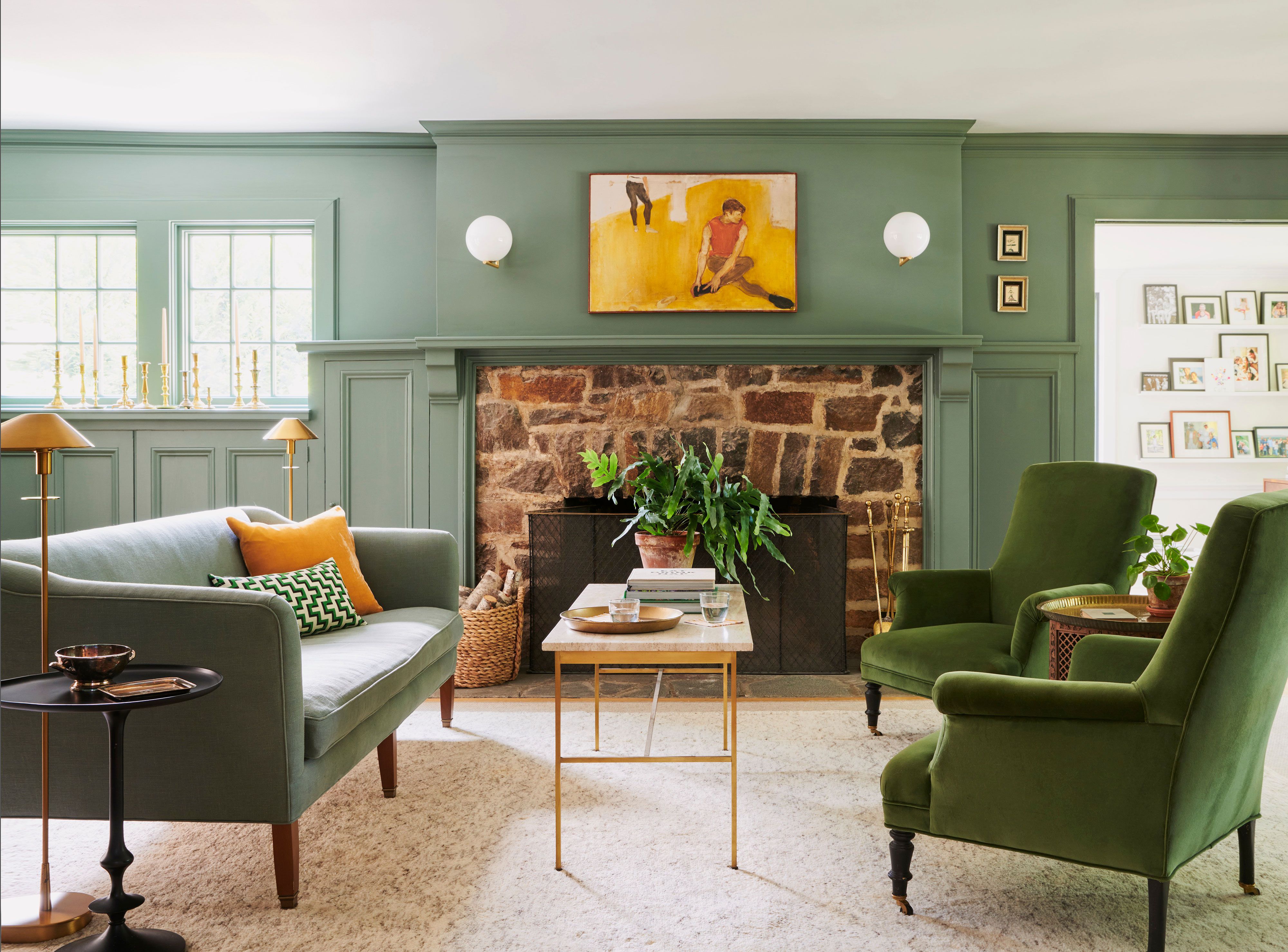 living room with traditional green and brown color palette with tufted sofas