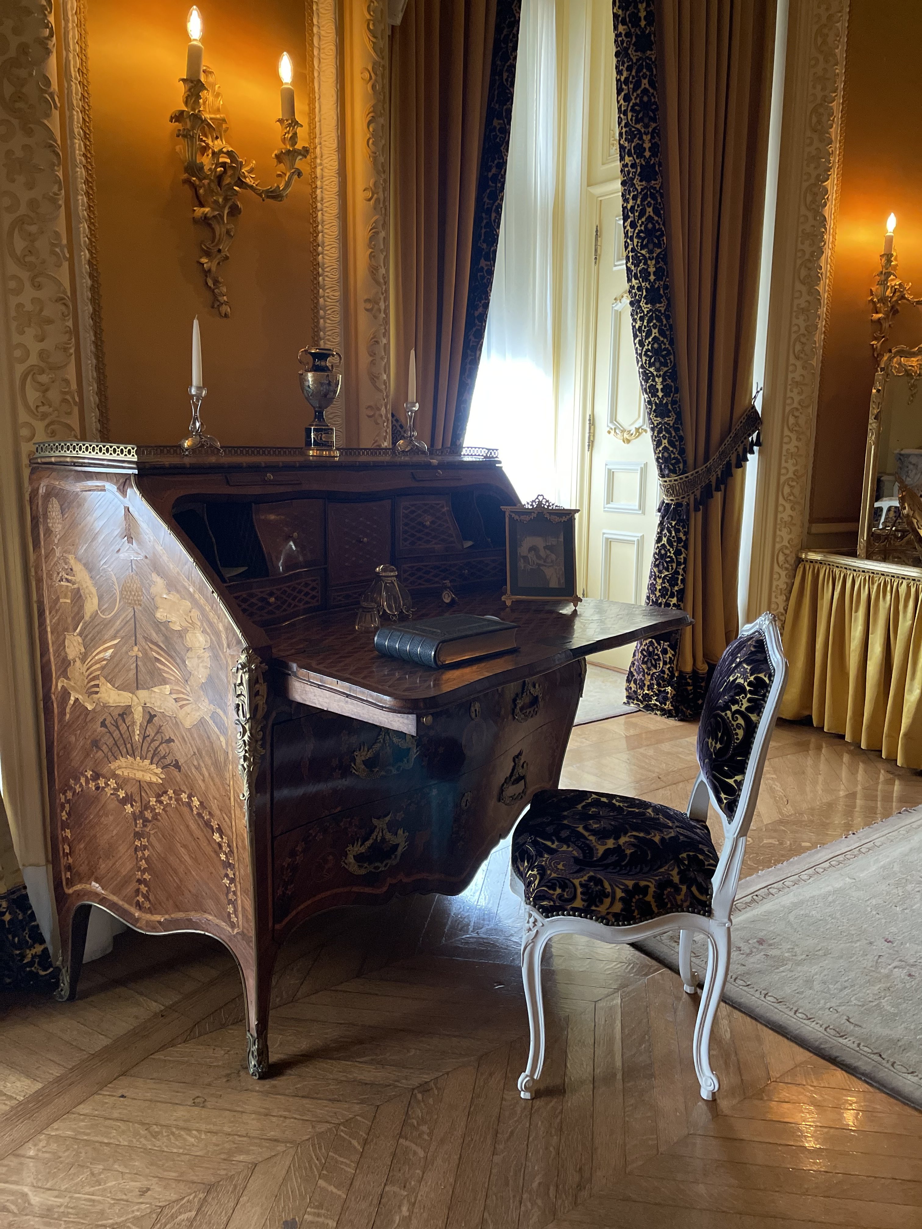 a vintage living room with a writing desk