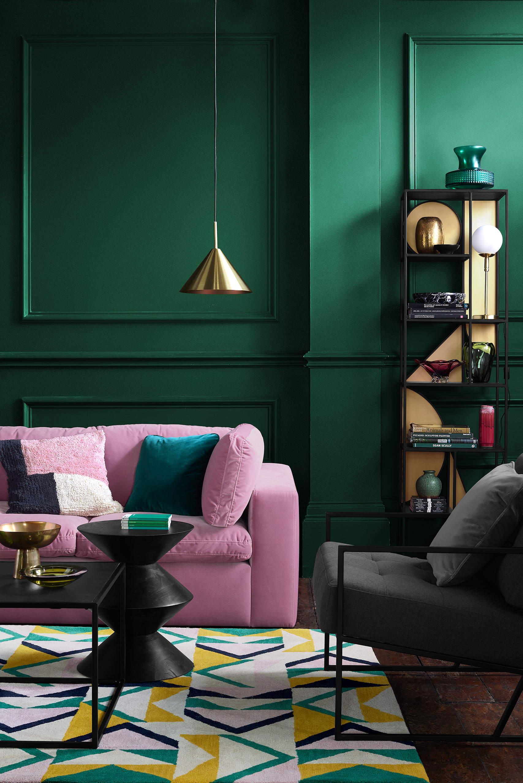 a pink and green living room with emerald green velvet seating
