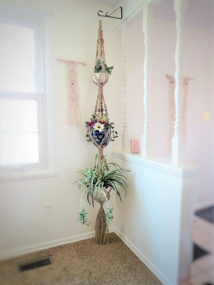 a vintage living room with macrame plant hangers