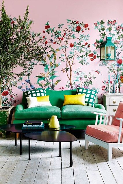 a pink and green living room with green wallpaper