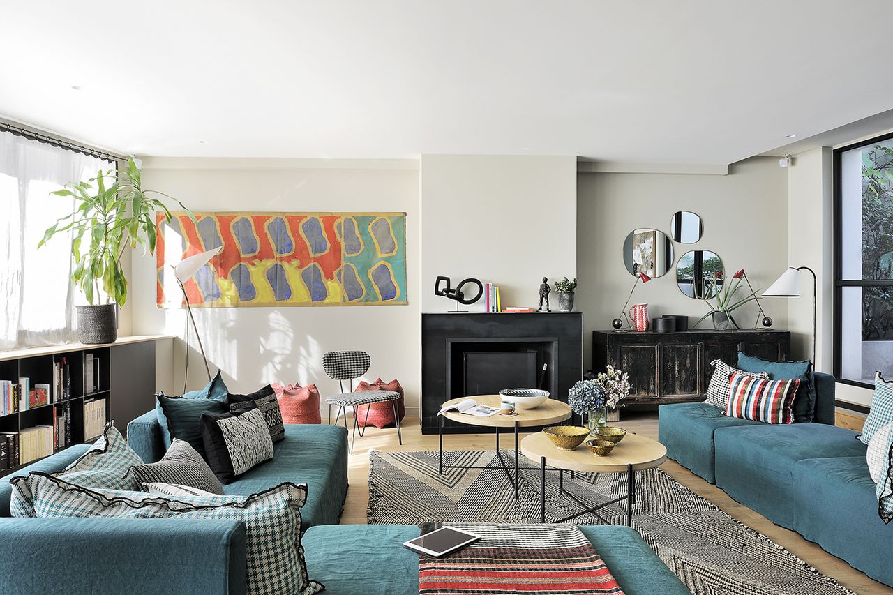 living room with eclectic cream sofa with colorful art