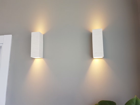 living room with ceramic wall lamps for a unique texture