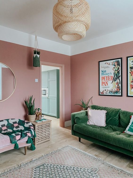 a pink and green living room with mirror