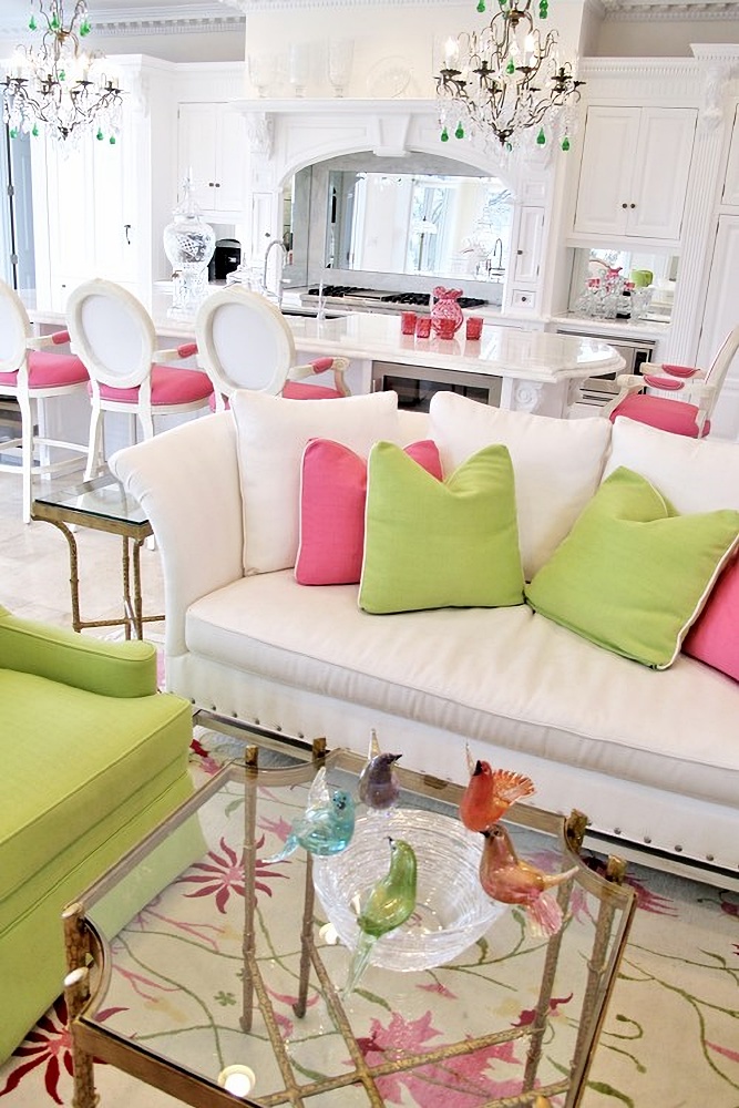 a pink and green living room with decorative bowls
