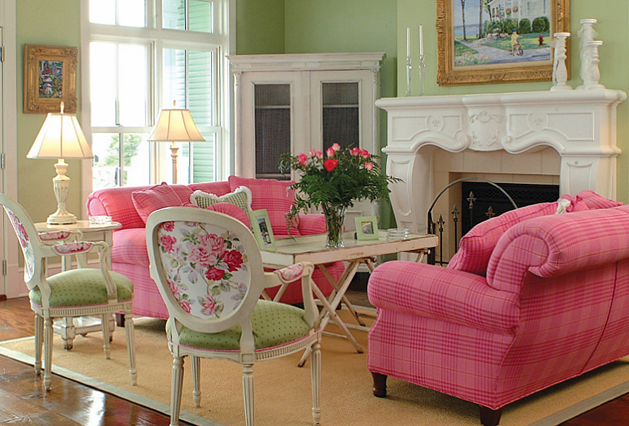 a pink and green living room with pink candles