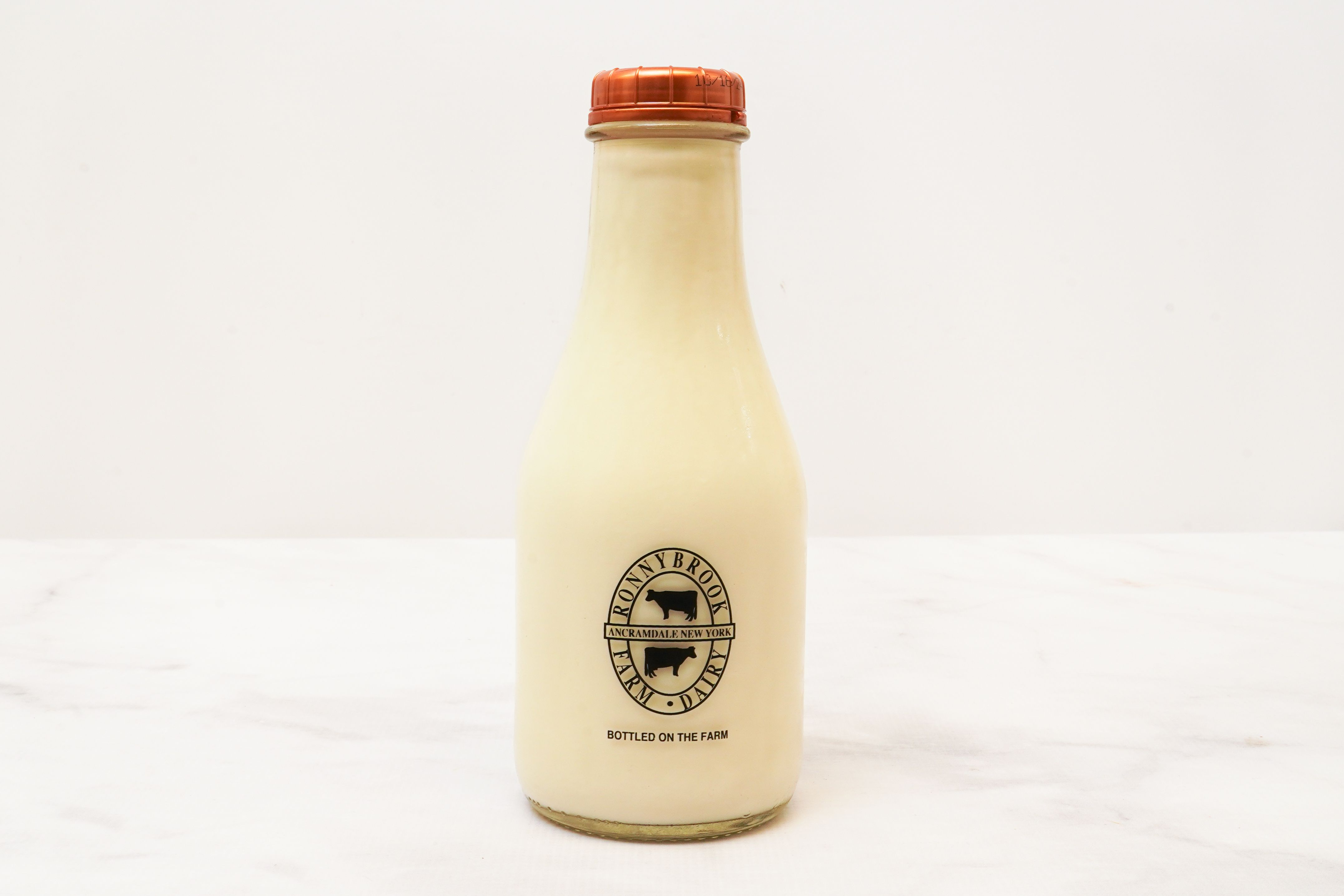 a fresh milk with creamline in glass bottle