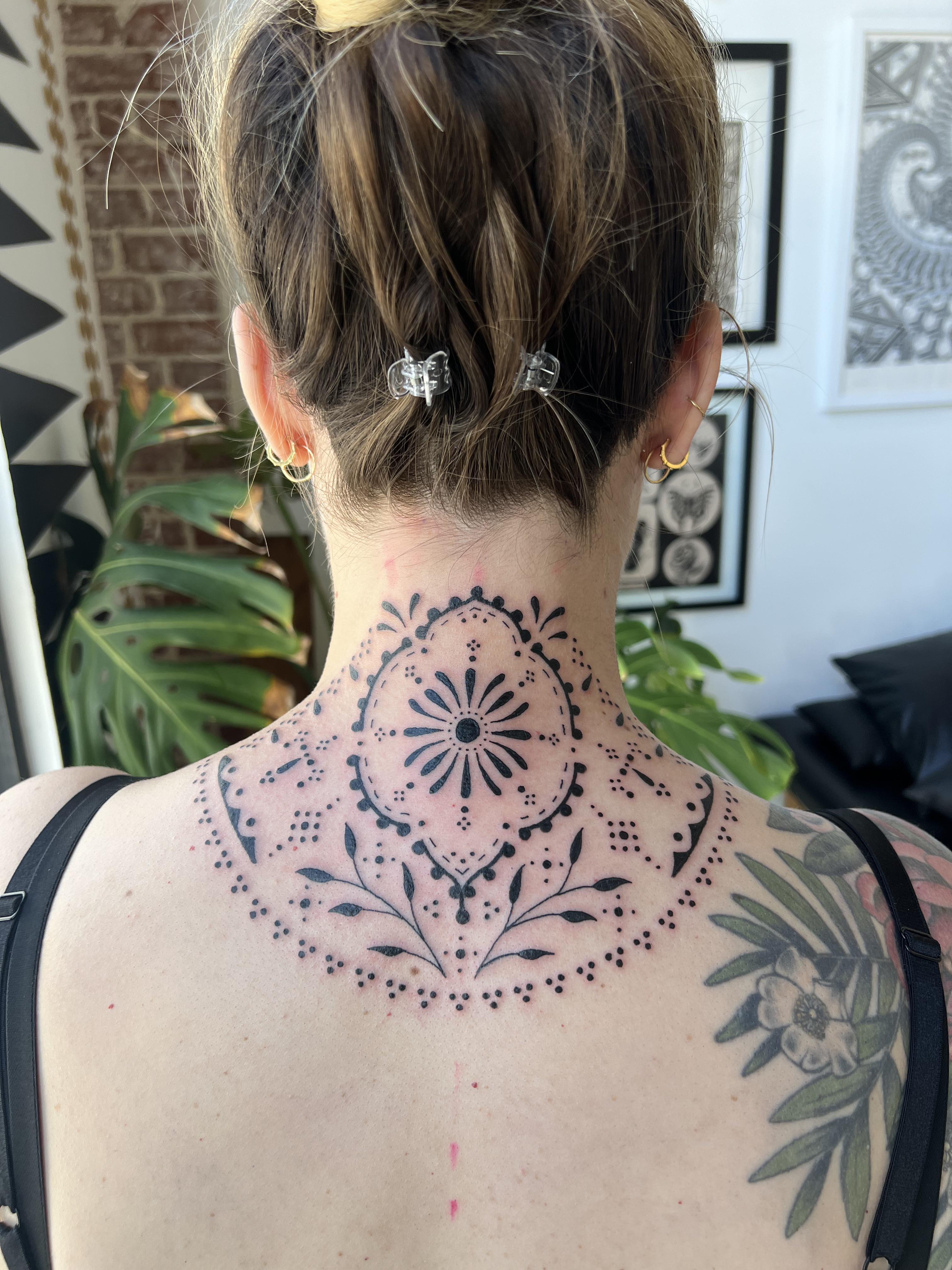Mandala magic meets neck artistry in this stunning geometric masterpiece that transforms the nape into a canvas of sacred symmetry. The intricate dotwork and flowing botanical elements create a mesmerizing focal point that's both boldly modern and timelessly spiritual. Perfect for those who want their ink to make a statement even when their hair is up ✨