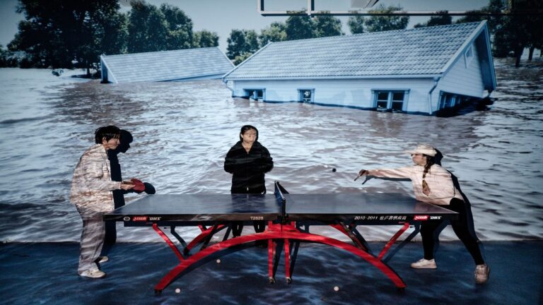Maldives family posed with a diver in their home showing future sea rise