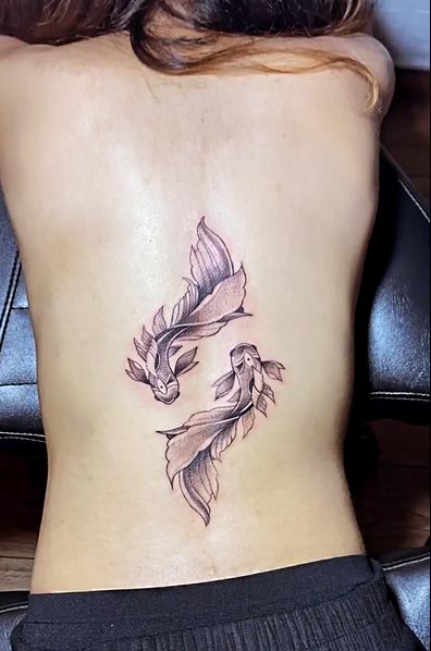 Delicate feathers dance gracefully down this spine placement, creating an ethereal cascade that follows the natural curve of the back. The soft linework and organic flow make this piece feel like it's floating just beneath the skin, while the strategic positioning transforms the spine into a beautiful focal point. ✨