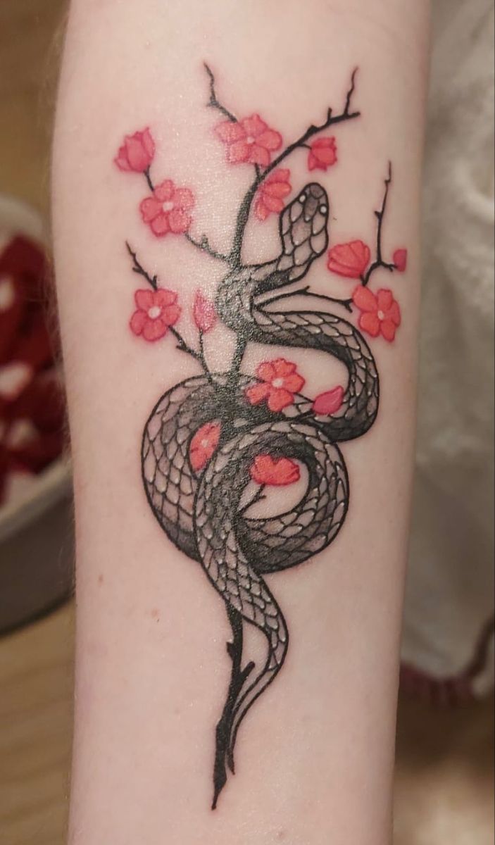 A snake and cherry tattoo that’s playful but sharp