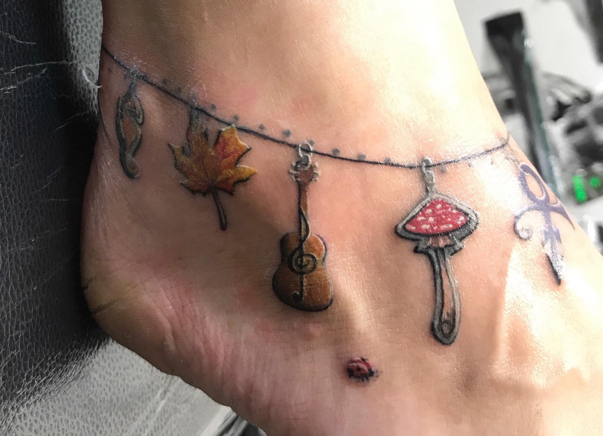 A tiny charm bracelet in tattoo form